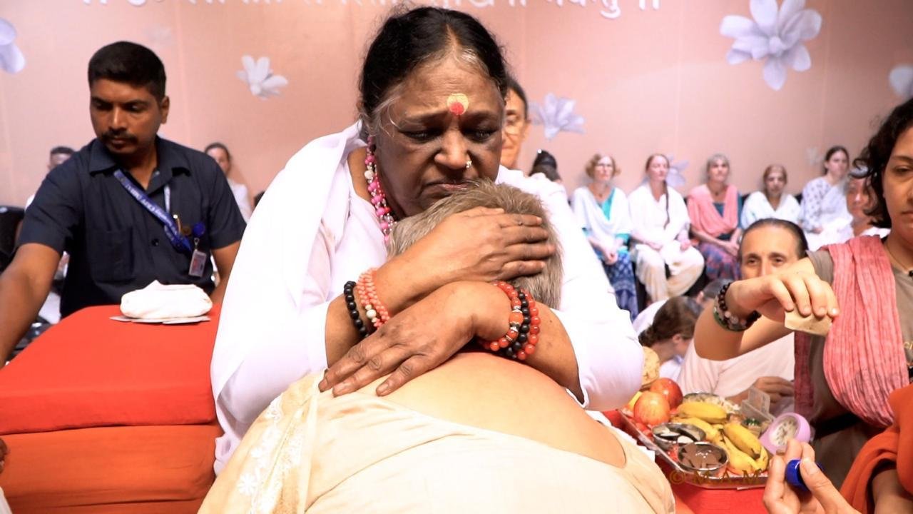 Prof Seema Parihar receiving blessings from Amma
